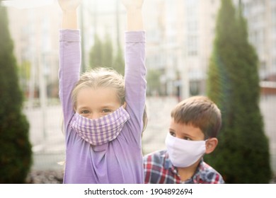 Little Children With Medical Face Masks On Playground During Covid-19 Quarantine