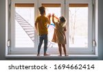 Little children on background of painting rainbow on window. Photo of kids leisure at home. Positive visual support during quarantine Pandemic Coronavirus Covid-19 at home. Family background