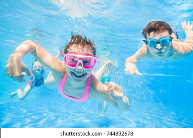 little children  playing and  swimming  in pool  under the water.