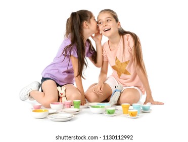 Little children playing tea party with toys on white background. Indoor entertainment