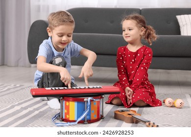 Little children playing toy musical instruments at home - Powered by Shutterstock