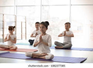 Little Children Practicing Yoga In Gym