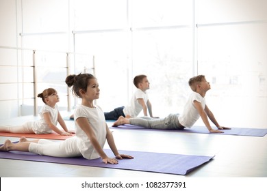 Little Children Practicing Yoga In Gym