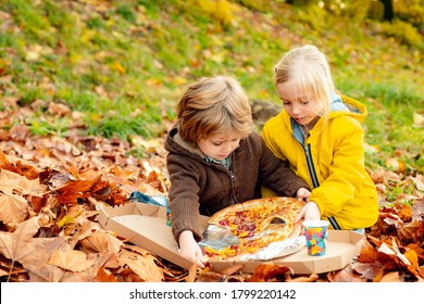 Little Children Seat On Plaid In Park Eating Pizza In Fall Autumn Dressed With Knitted Cap And Sweater On Picnic