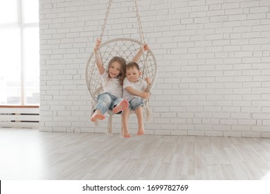 Little Children Sit In A Circular Rope Swing
