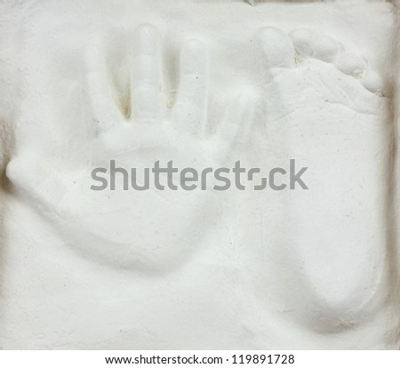 Little child's hand and foot print in gypsum