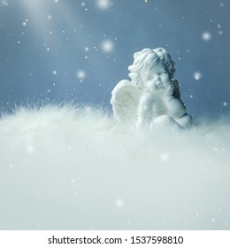 Little Christmas angel on silver background