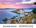 Little church of Agios Isidoros in the sea over the rocks, Chios island, Greece.