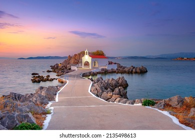 Little church of Agios Isidoros in the sea over the rocks, Chios island, Greece. - Shutterstock ID 2135498613