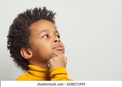 Little Clever Curious Black Child Boy Thinking On White Background, Close Up Portrait