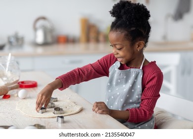 Little Cook Cute Black Girl Preschooler With Bushy Hair Making Cookies For Her Family, Cutting Various Figures On Rolling Dough For Pastry, African American Child Enjoying Cooking, Copy Space