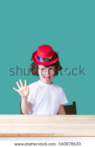 Similar – funny child with clown nose on blue background