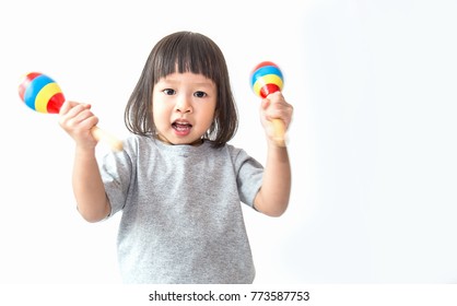 Little Cute Asian Girl Playing The Maracas, Preschool Play Group, Music Learning By Doing And Education Concept