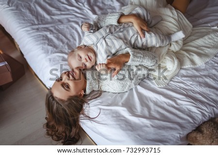 Similar – Top view of happy children having breakfast in the bed with their mother in a relaxed morning