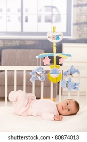 Little Cute Baby Girl Lying In Crib With Toy Mobile.?