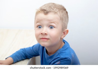 Little Cute Blue Eyed Boy Is Looking With Wide Opened  Eyes Surprisingly Shocked - Children Real Emotions