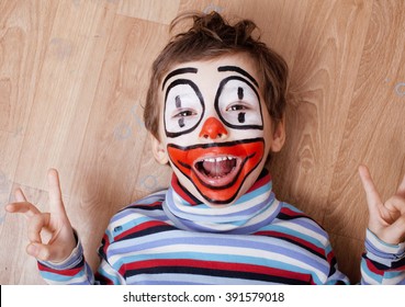 little cute boy with facepaint like clown, pantomimic expressions close up - Powered by Shutterstock