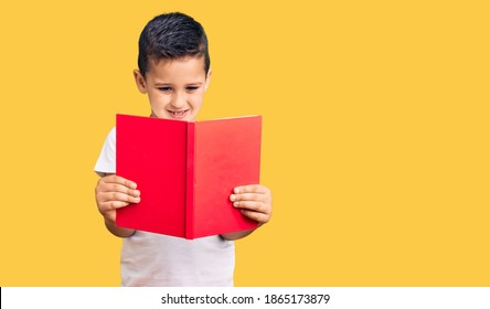 Little Cute Boy Kid Reading A Book Looking Positive And Happy Standing And Smiling With A Confident Smile Showing Teeth 