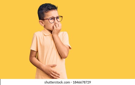 Little Cute Boy Kid Wearing Casual Clothes And Glasses Looking Stressed And Nervous With Hands On Mouth Biting Nails. Anxiety Problem. 