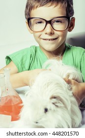 little cute boy with medicine glass isolated wearing glasses smiling close up