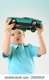 Little Cute Boy With A Vintage Blue Car. Studio Shot