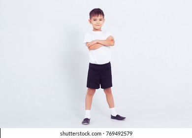 Little cute child boy in white dance form at white background