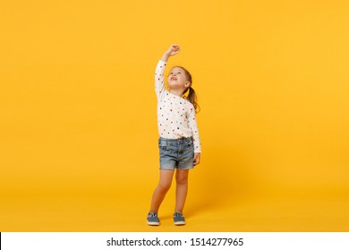 Little Cute Child Kid Baby Girl 4-5 Years Old Wearing Light Denim Clothes Isolated On Pastel Yellow Wall Background, Children Studio Portrait. Mother's Day, Love Family, Parenthood Childhood Concept