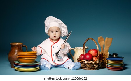 little cute cook with cutlery sitting on blue background