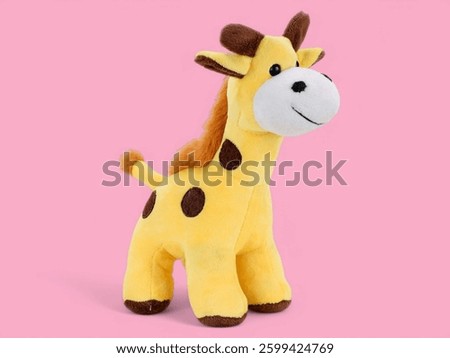 Little cute giraffe toy on the pink background