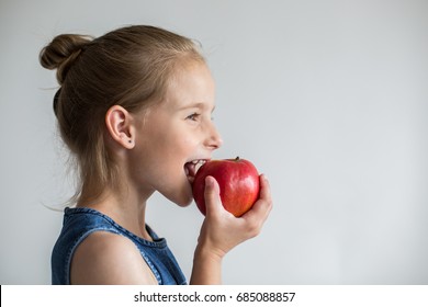 Little Cute Girl Eating Red Apple