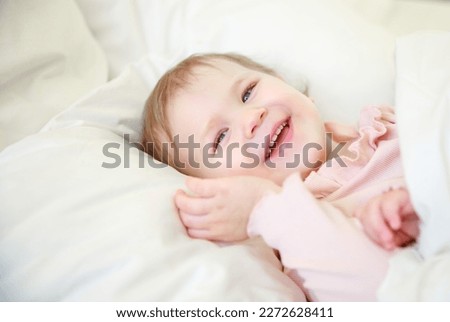 Similar – Little girl smiling lying over the bed