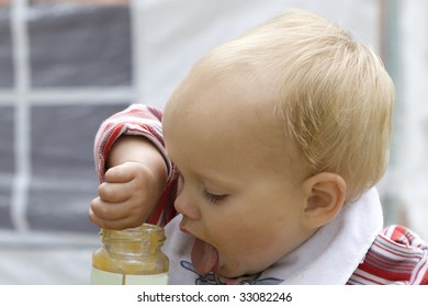 Little Cute Girl One Years Old Eating Apple Sauce