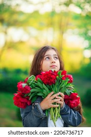 Little Cute Girl With Peony Flowers. Child  Playing In Summer Garden. Kids Gardening. Children Play Outdoors. Toddler Kid With Flower Bouquet For Birthday Or Mother S Day.