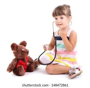 Little cute girl playing doctor, isolated on white