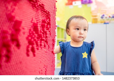 Little Cute Girl Playing Red Pin Art Board. Concept Of Play Development. 