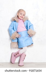 Little Cute Girl Posing In Fashion Blue Winter Outfit