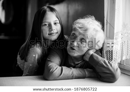 Similar – Young woman talking to elderly woman in wheelchair