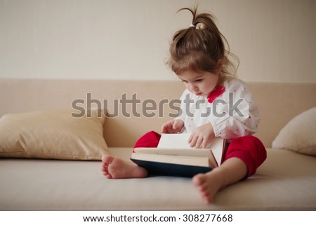 Similar – young caucasian little boy playing with tablet on couch