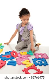 Little Cute Girl Solving Number Alphabet Puzzle