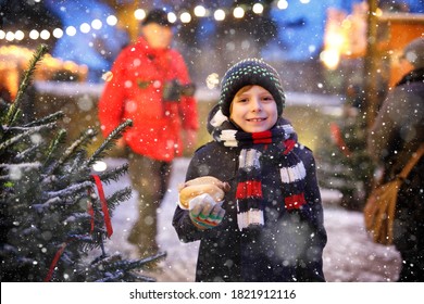 Little Cute Kid Boy Eating German Sausage And Drinking Hot Children Punch On Christmas Market. Happy Child On Traditional Family Market In Germany. Laughing Boy In Colorful Winter Clothes