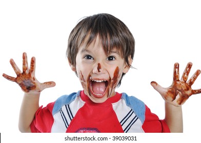 Little Cute Kid With Chocolate On Face And Hands