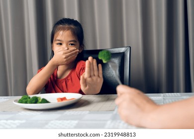 Little cute kid girl refusing to eat healthy vegetables. Children do not like to eat vegetables. - Powered by Shutterstock