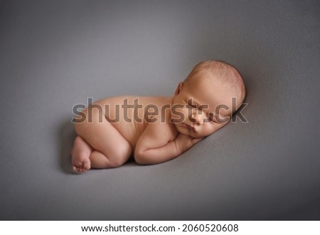 Similar – Baby yawning lying on a carpet