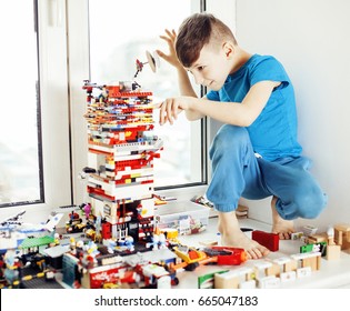 little cute preschooler boy playing lego toys at home happy smil