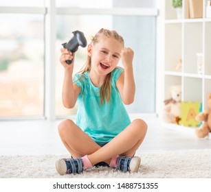 Little Cute Sibling Making Victory Dance, After Playing Video Games On Console Indoors