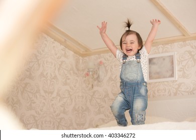 Little Cute Toddler Girl Jumping On The Bed