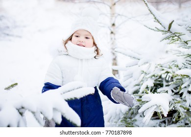 Little Cute Toddler Girl Walking Outdoors On Beautiful Sunny Winter Day, Exploring Nature