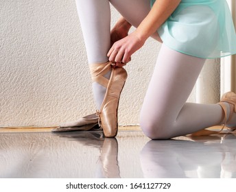 Little dancers tie pointe shoes. A lesson in classical Russian ballet. - Shutterstock ID 1641127729