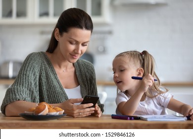 Little Daughter Distracted From Drawing With Felt-tip Pens, Homework, Looking At Phone Screen With Mother, Children Electronic Device Addiction, Mum Surfing Internet, Chatting In Social Network