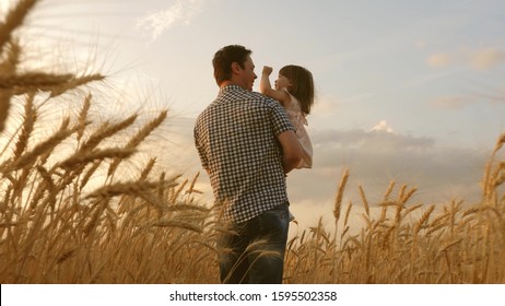 little daughter on fathers shoulders. happy child and father are playing in field of ripening wheat. baby boy and dad travel on field. kid and parent play in nature. happy family and childhood concept - Powered by Shutterstock